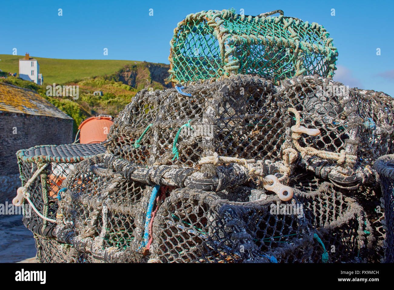 fish traps lying in a Cornish harbour Stock Photo