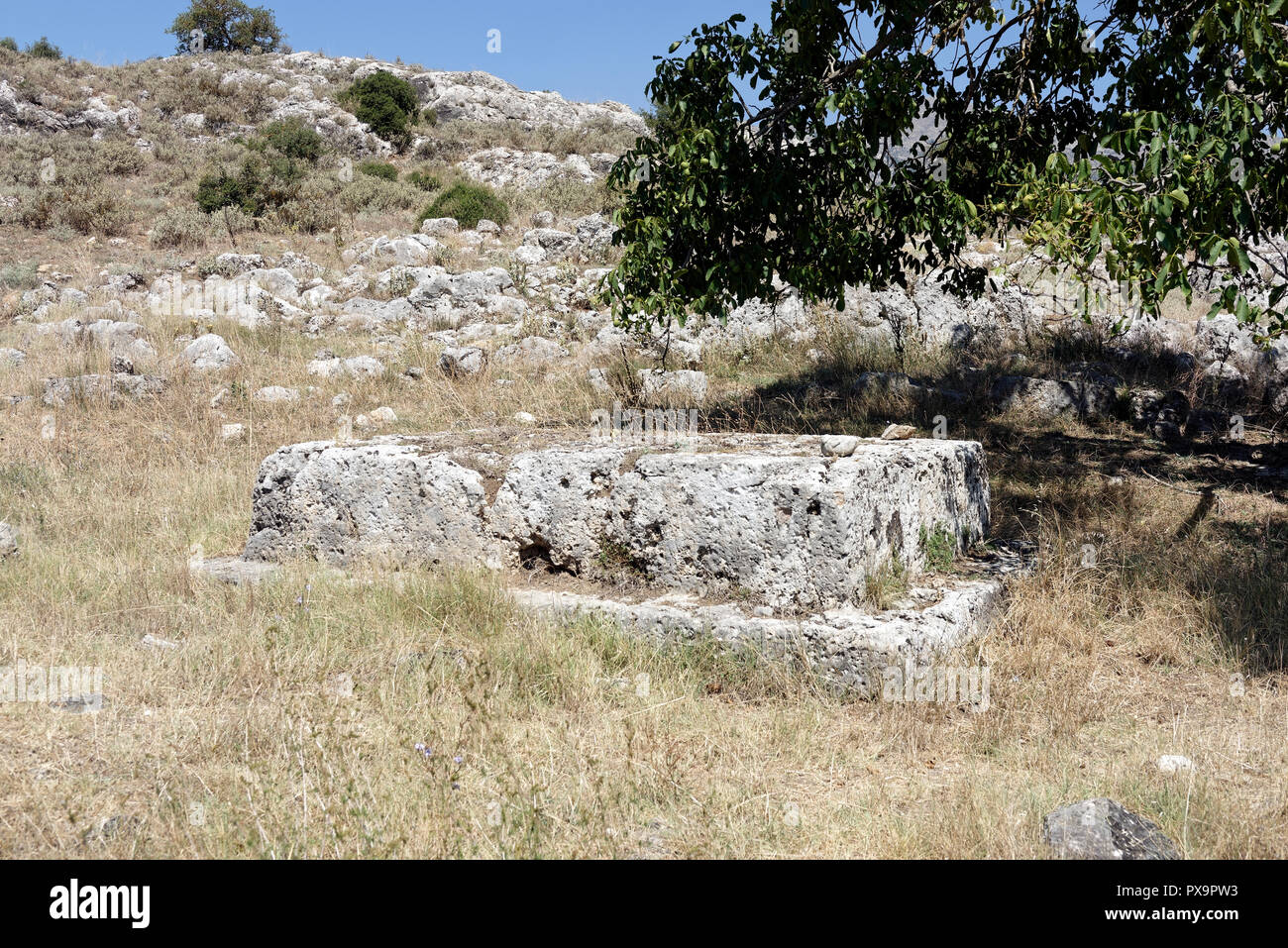 The foundation base of pedestal or platform for a monument or shrine. Lower city, Ancient Stymphalos. Stymphalia. Peloponnese. Greece. Stock Photo