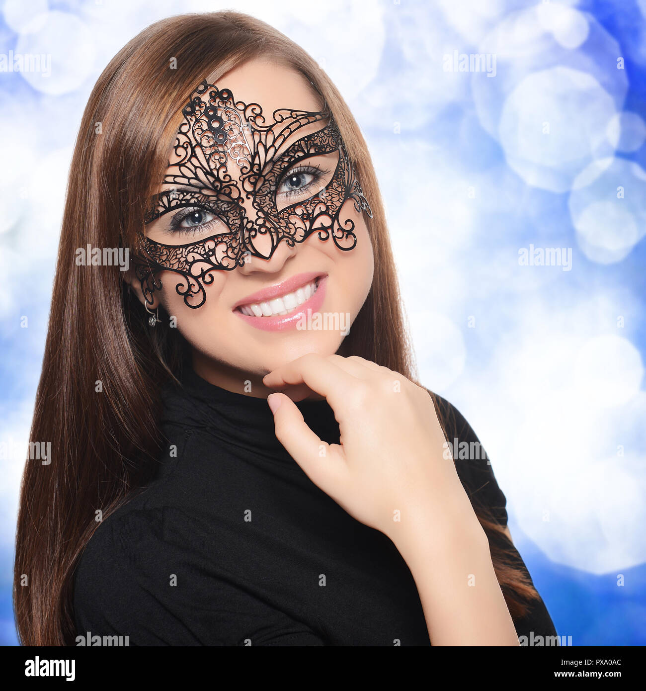 Beautiful woman in carnival mask over blue background Stock Photo Alamy
