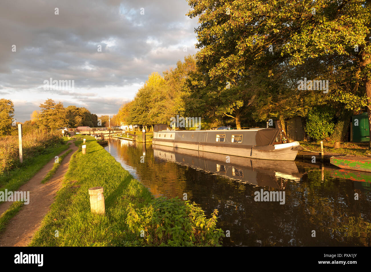Catteshall Lock on the River Wey, Godalming, at sunset on a lovely summers evening, with calm canal waters Stock Photo