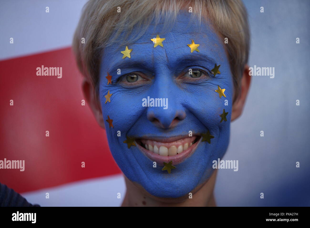 An anti-Brexit campaigner with her face painted in the colours of the European Union flag takes part in the People's Vote March for the Future in London, a march and rally in support of a second EU referendum. Stock Photo