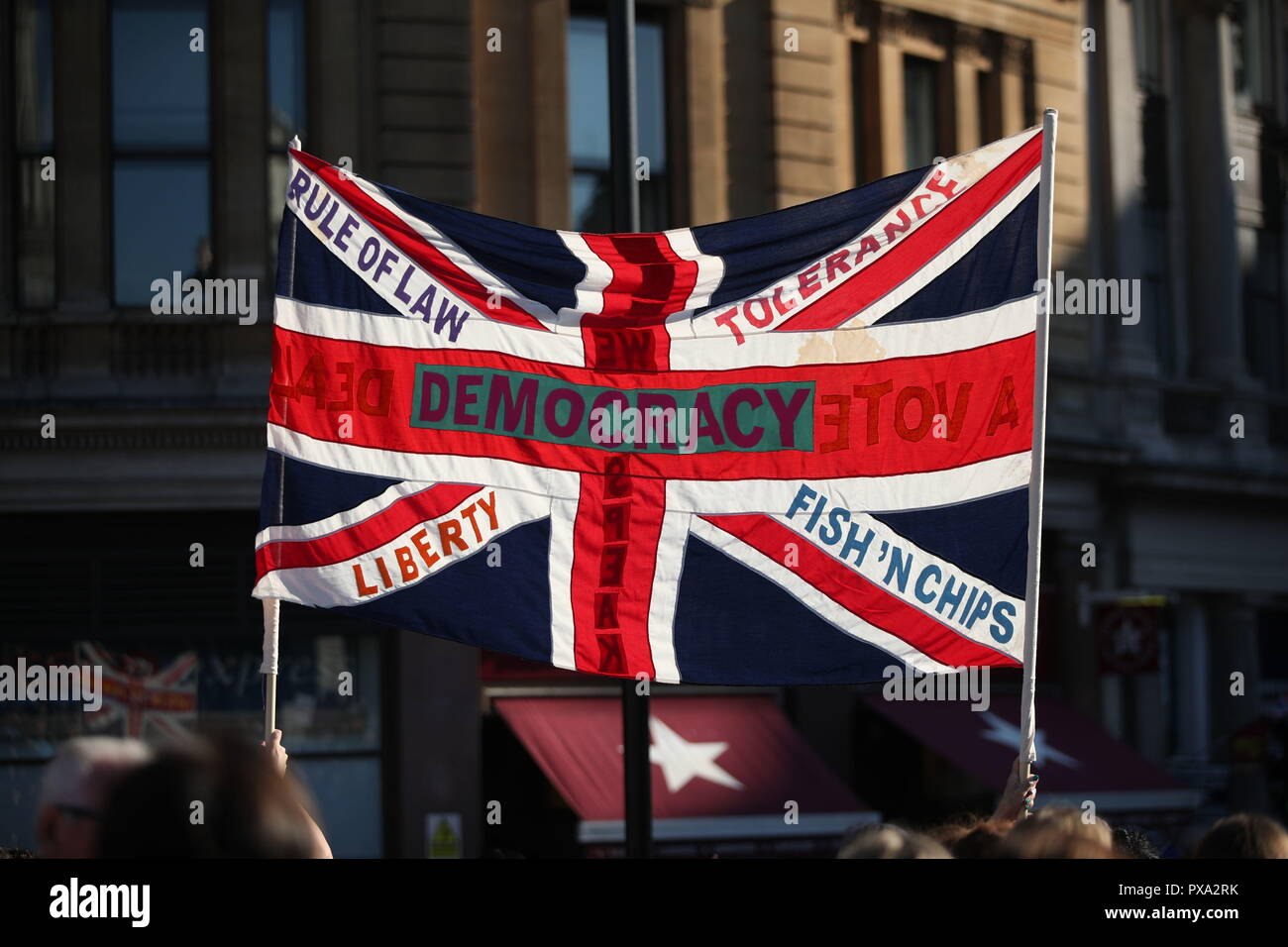 A protester holds a Union flag with slogans including &quot;Democracy&quot;, &quot;Rule of Law&quot;, &quot;Liberty&quot;, &quot;Tolerance&quot; and &quot;Fish 'n' Chips&quot; during the People's Vote March for the Future in London, a march and rally in support of a second EU referendum. Stock Photo