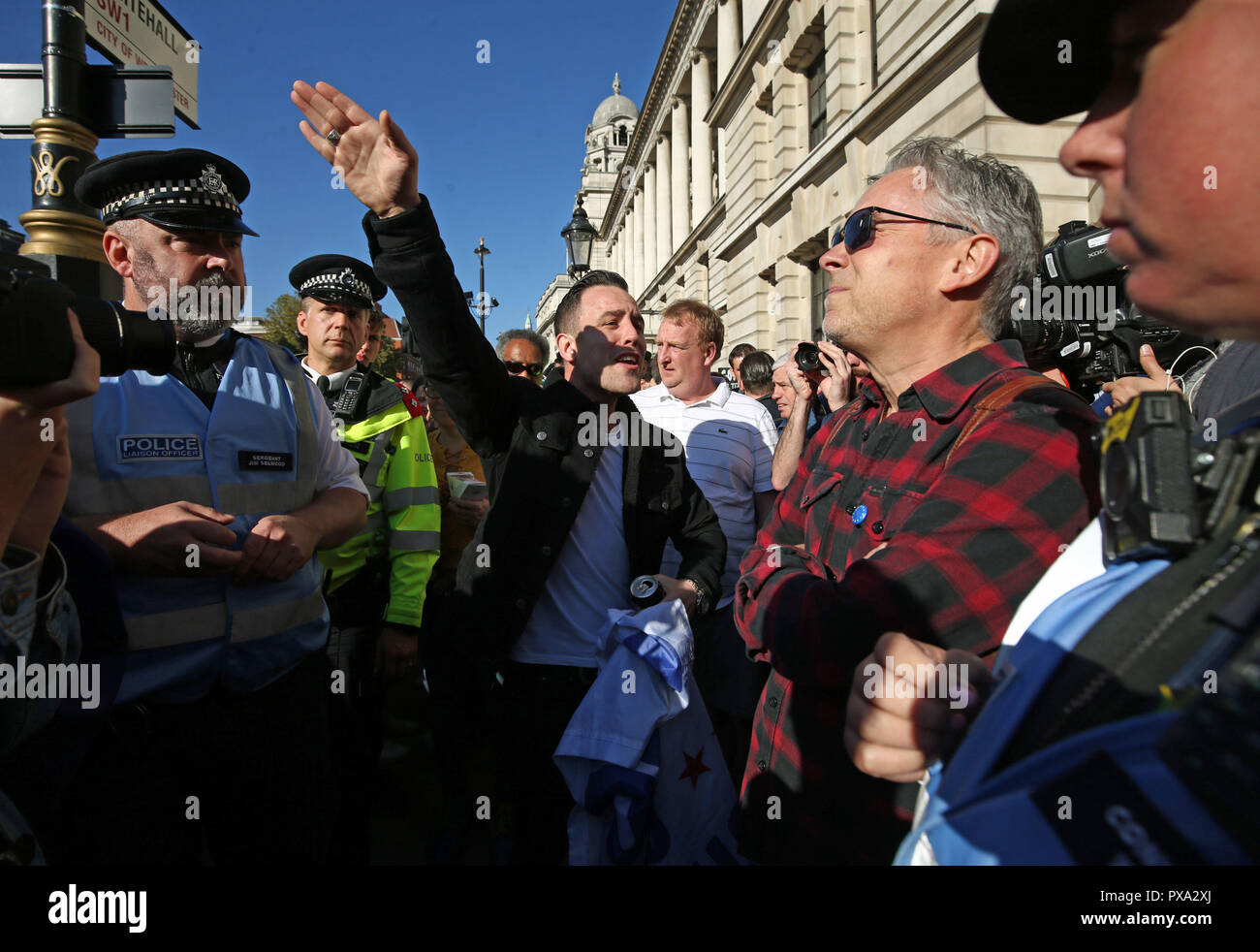 A man in favour of Brexit (centre) argues with people taking part in the People's Vote March for the Future in London, a march and rally in support of a second EU referendum. Stock Photo