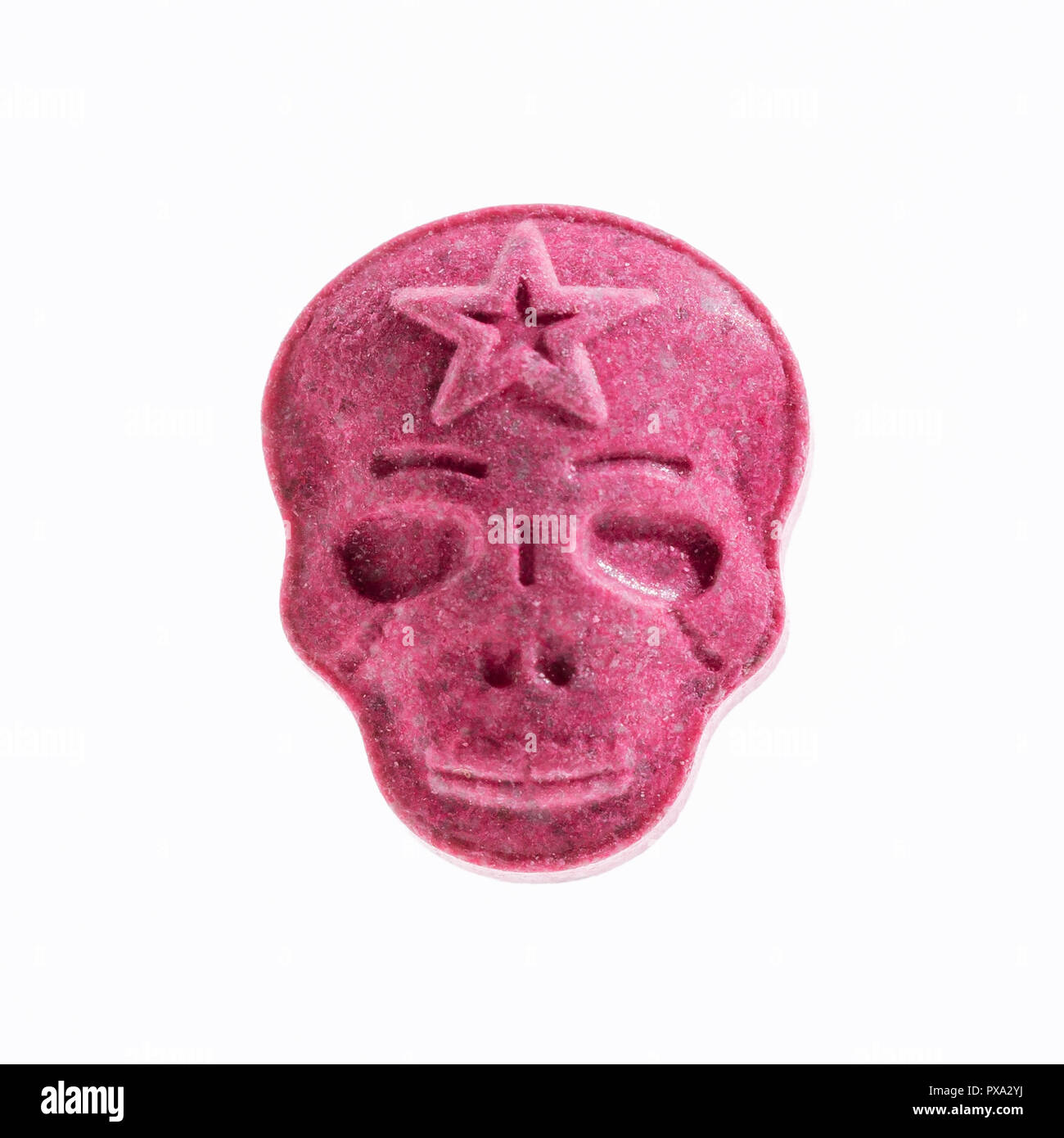 One Red Army Skull, Ecstasy, MDMA or medication pill shaped like a skull isolated on a white background. Stock Photo