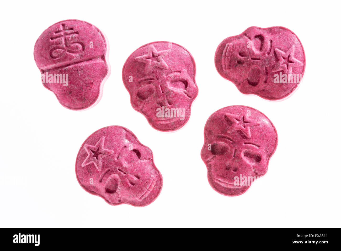 Five Red Army Skull, Ecstasy, MDMA or medication pills shaped like a skull isolated on a white background. Stock Photo