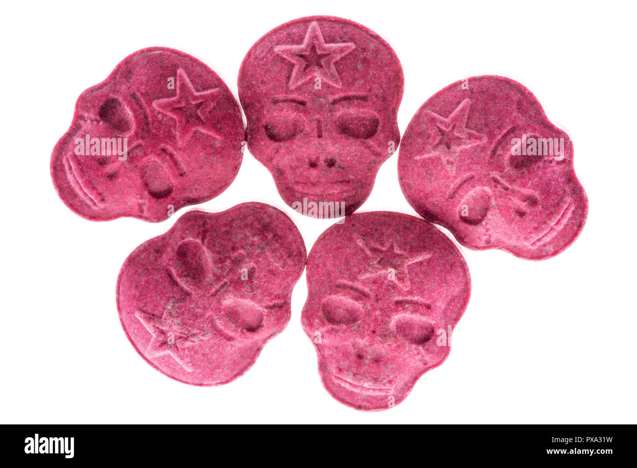 Five Red Army Skull, Ecstasy, MDMA or medication pills shaped like a skull isolated on a white background. Stock Photo