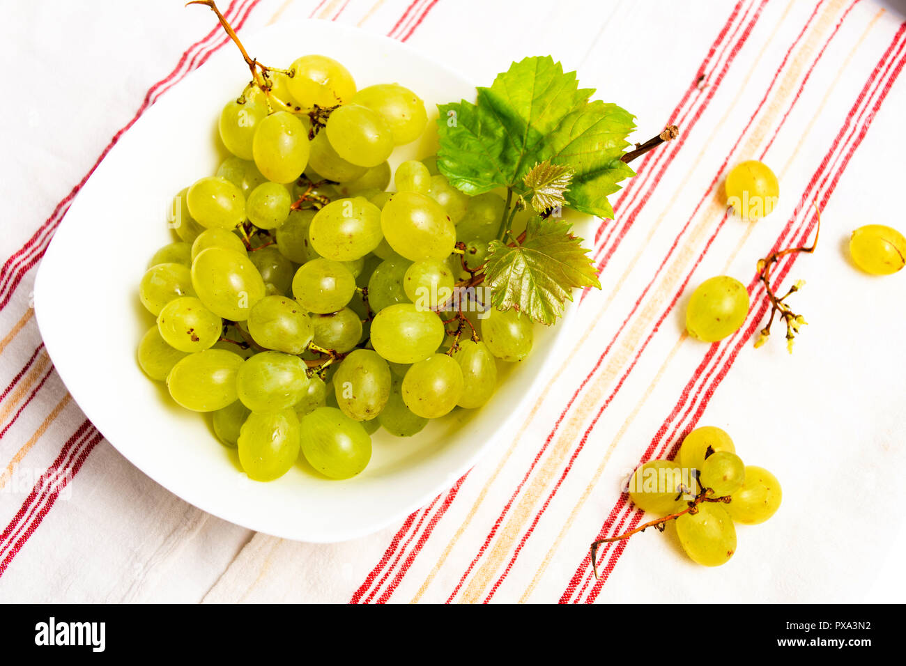 Green fresh grapes in a white bowl top view Stock Photo