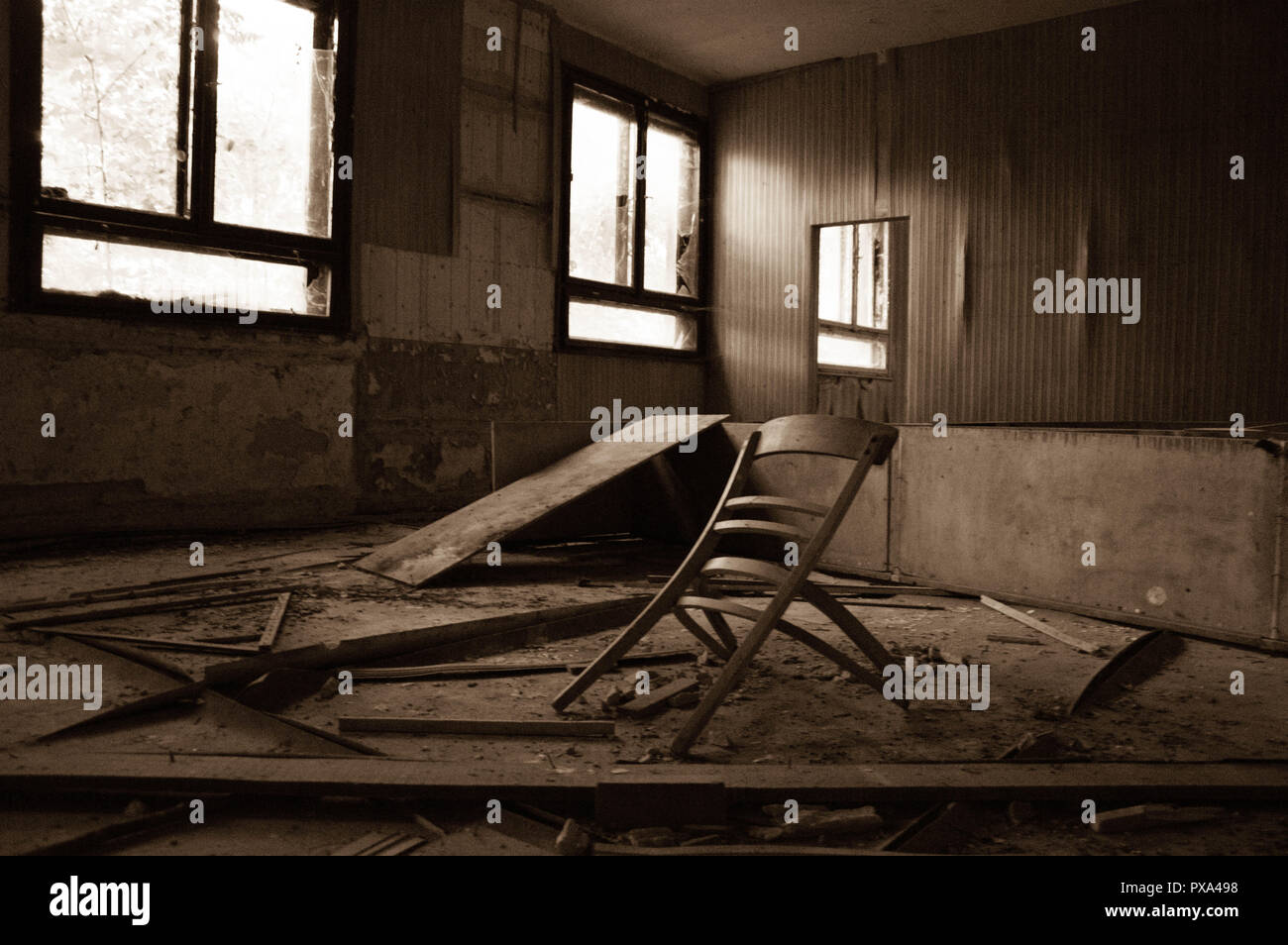 Broken furnitures in an abandoned building in a dirty room Stock Photo