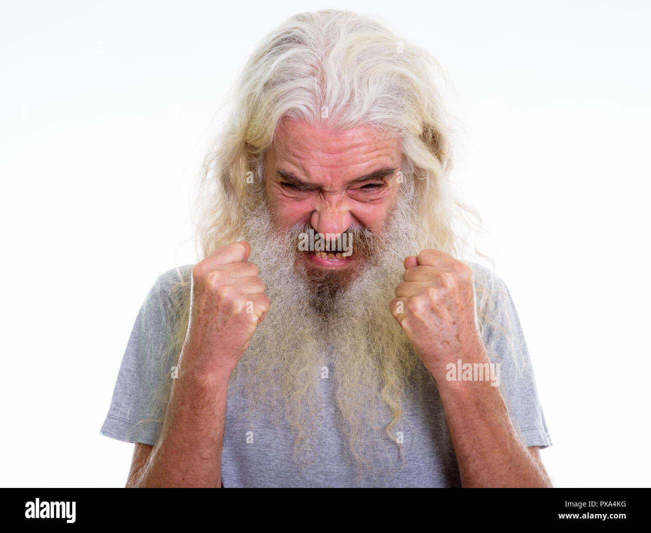 Close up of angry senior bearded man looking furious while raisi Stock Photo