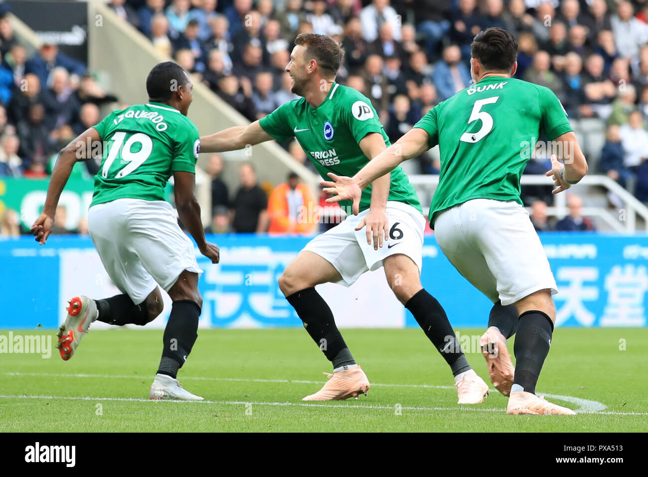 Brighton & Hove Albion's Jose Izquierdo, Dale Stephens and Lewis Dunk celebrate Beram Kayal's first goal of the game during the Premier League match at St James' Park, Newcastle. Stock Photo