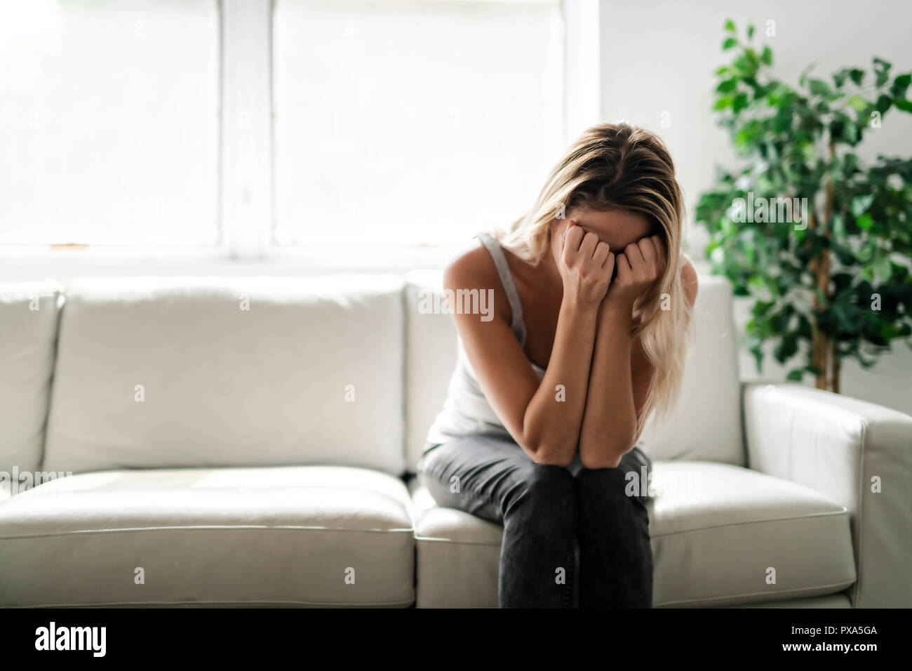 A Unhappy lonely depressed woman at home living room Stock Photo - Alamy