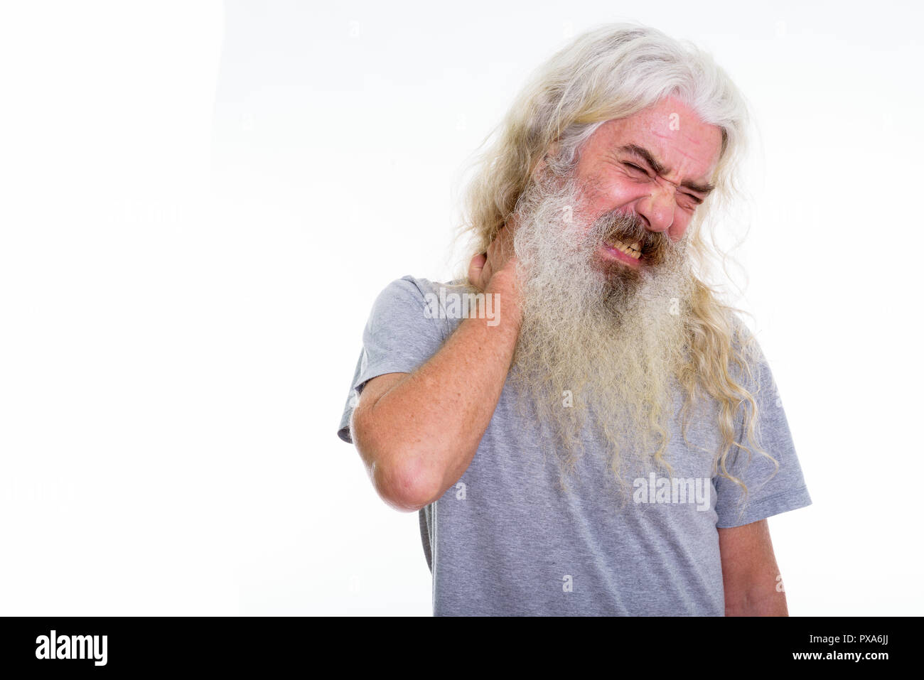 Studio shot of stressed senior bearded man having pain in the ne Stock Photo