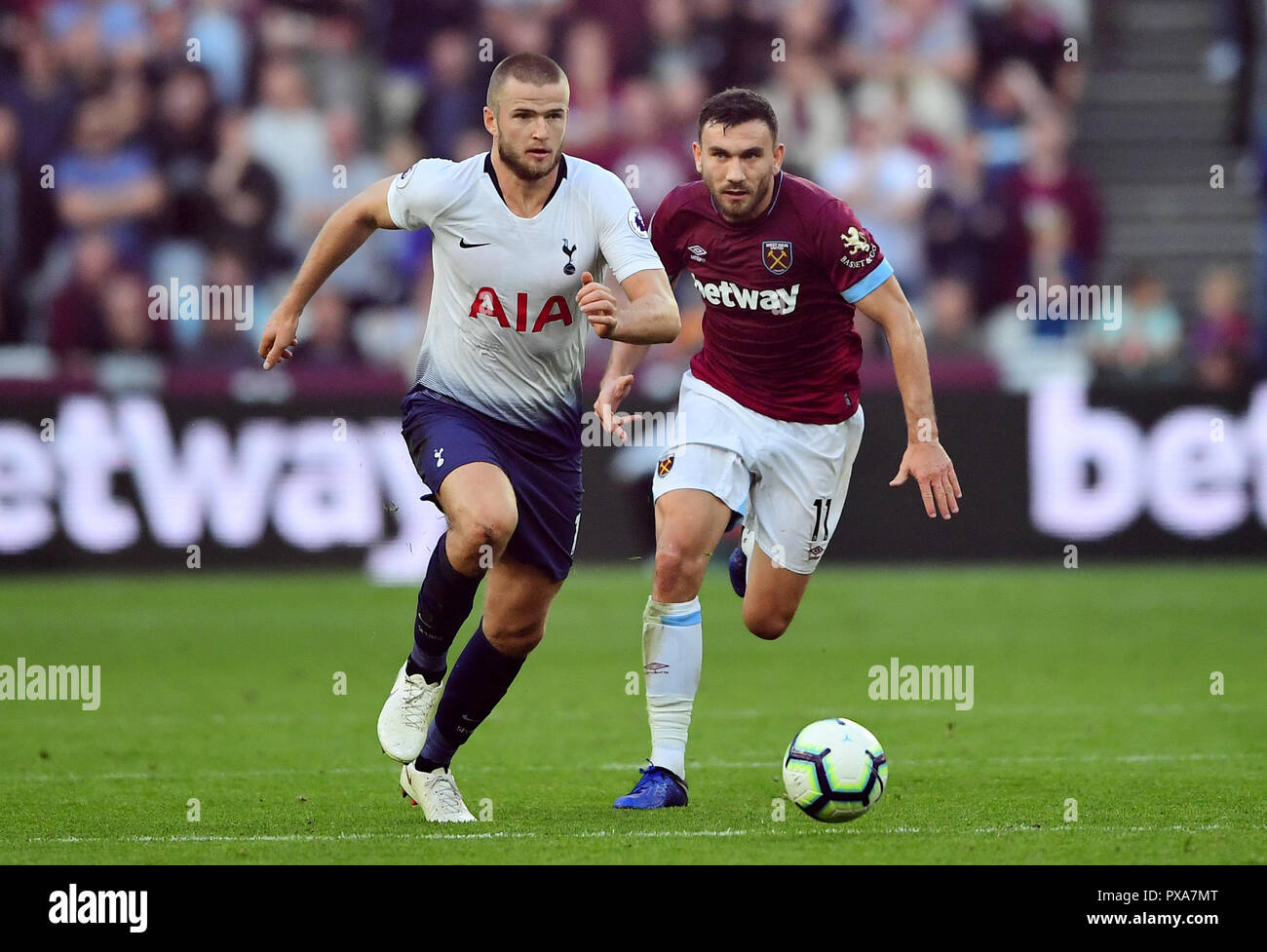 Tottenham Hotspur's Eric Dier (left) and West Ham United's Robert Snodgrass battle for the ball during the Premier League match at London Stadium. Stock Photo