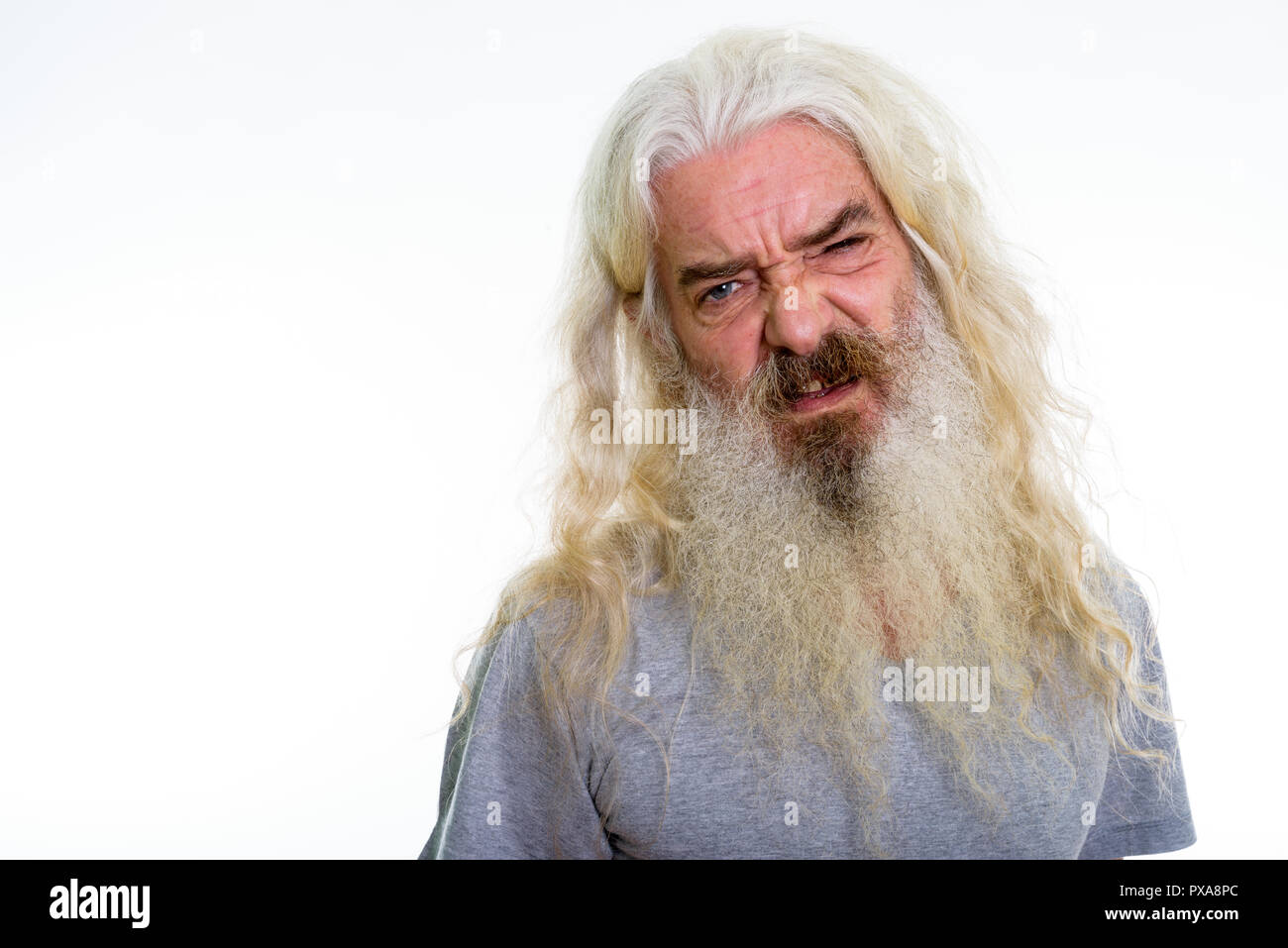 Close up of senior bearded man looking disgusted  Stock Photo
