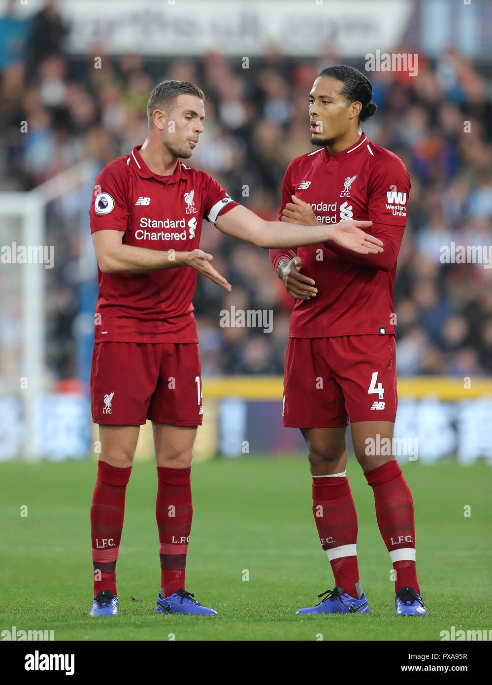 Liverpool's Jordan Henderson (left) and Virgil van Dijk during the Premier League match at the John Smith's Stadium, Huddersfield. Stock Photo