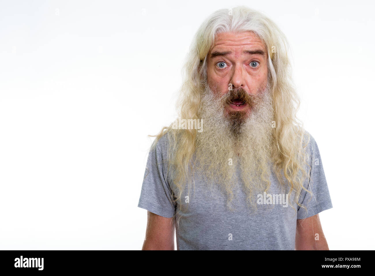 Studio shot of senior bearded man looking shocked Stock Photo