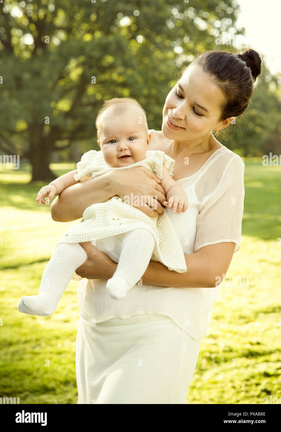 Mother holding baby girl on her hands Stock Photo