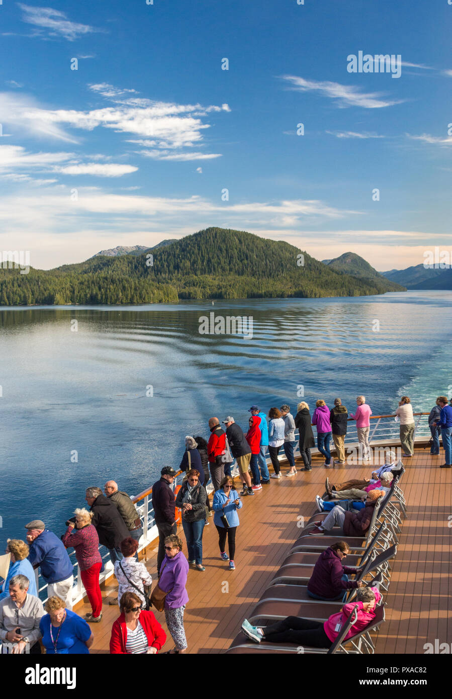 Cruise ship passengers aboard The Volendam, viewing beautiful scenery of the narrow and calm Principe Channel, part of the Inside passage route on the Stock Photo