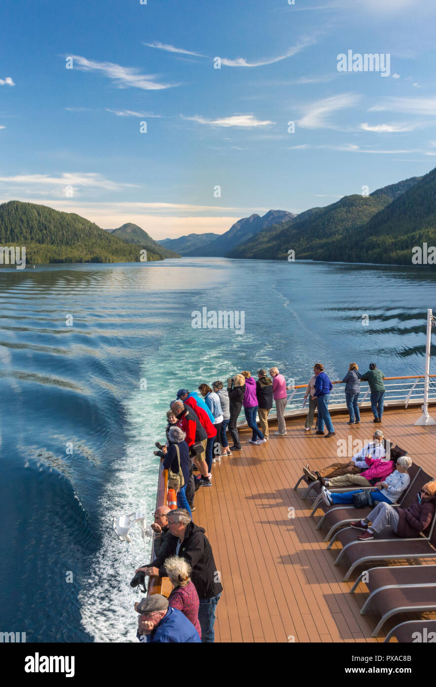 Cruise ship passengers aboard The Volendam, viewing beautiful scenery of the narrow and calm Principe Channel, part of the Inside passage route on the Stock Photo