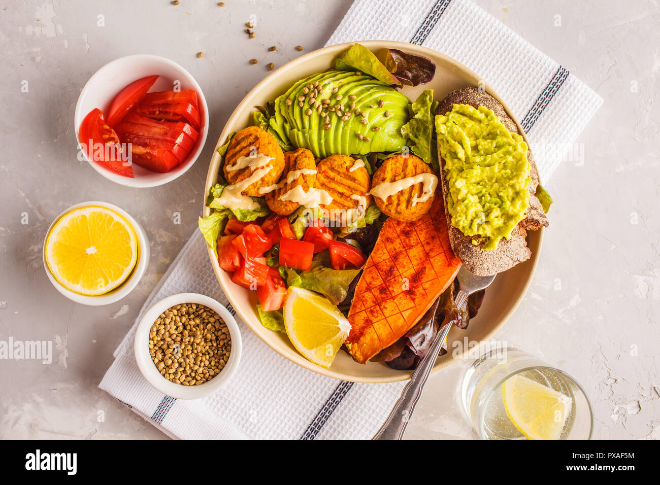 Vegan Rainbow bowl: meatballs vegetable, avocado, sweet potato and salad. Plant based diet concept. Stock Photo