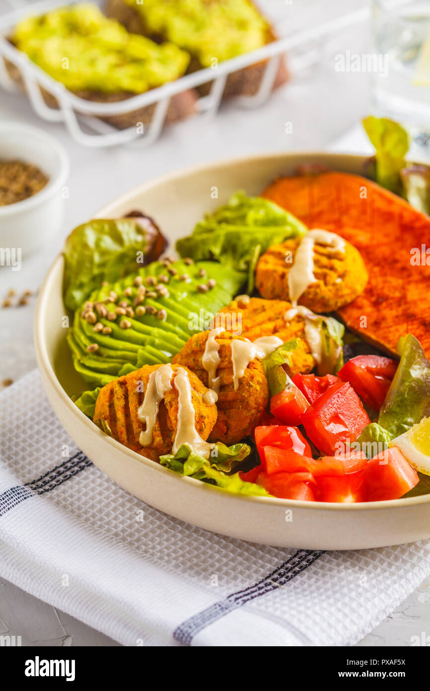 Vegan Rainbow bowl: meatballs vegetable, avocado, sweet potato and salad. Plant based diet concept. Stock Photo