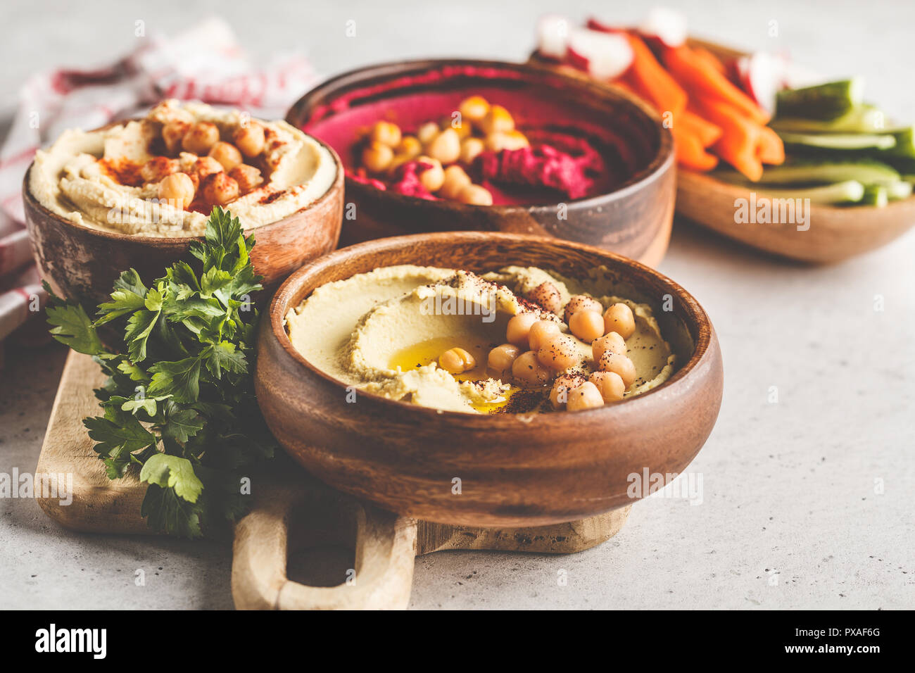 Different hummus bowls. Chickpea hummus, avocado hummus and beet hummus