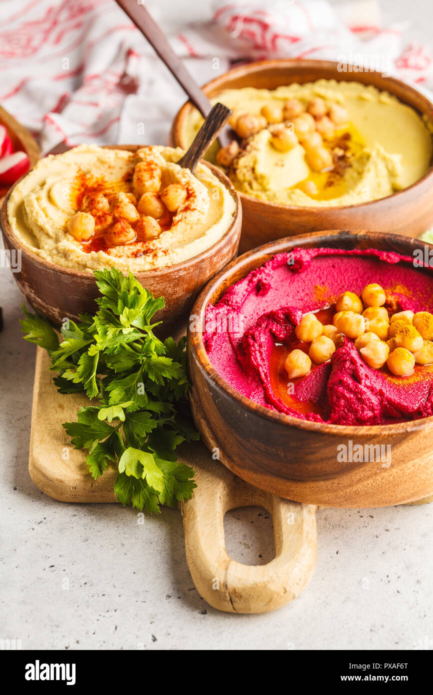 Different hummus bowls. Chickpea hummus, avocado hummus and beet hummus