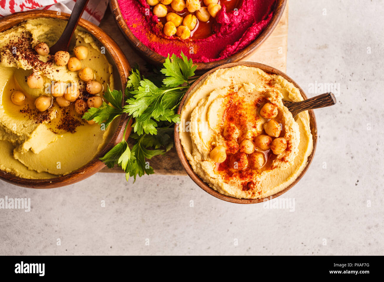 Different hummus bowls. Chickpea hummus, avocado hummus and beet hummus