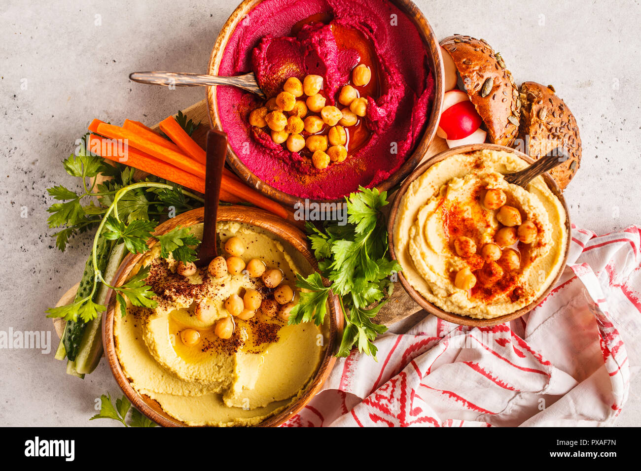 Different hummus bowls. Chickpea hummus, avocado hummus and beet hummus