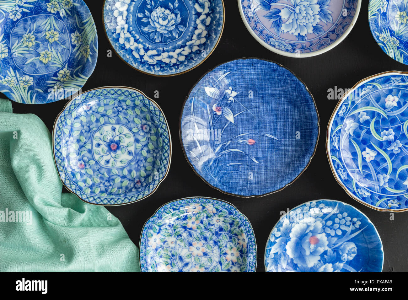Blue and white decorative Japanese plates on black background - Top view photo of collection of ceramic plates Stock Photo