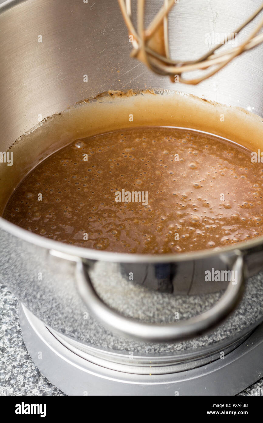 Chocolate cake batter in mixer bowl on kitchen table close up Stock Photo