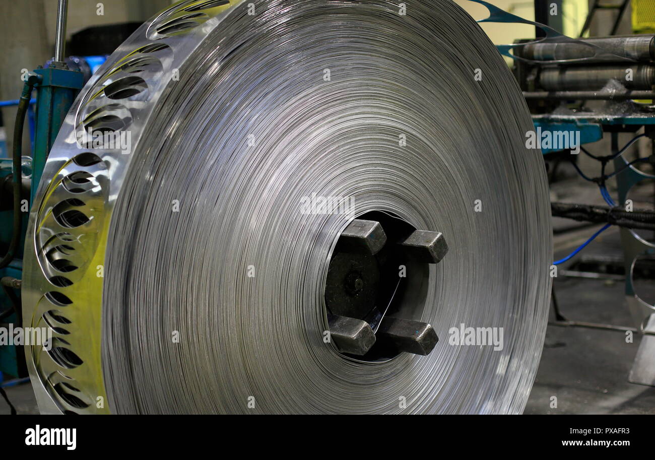 View of finished aluminum sheet rolls in a factory producing semi-finished products. Stock Photo