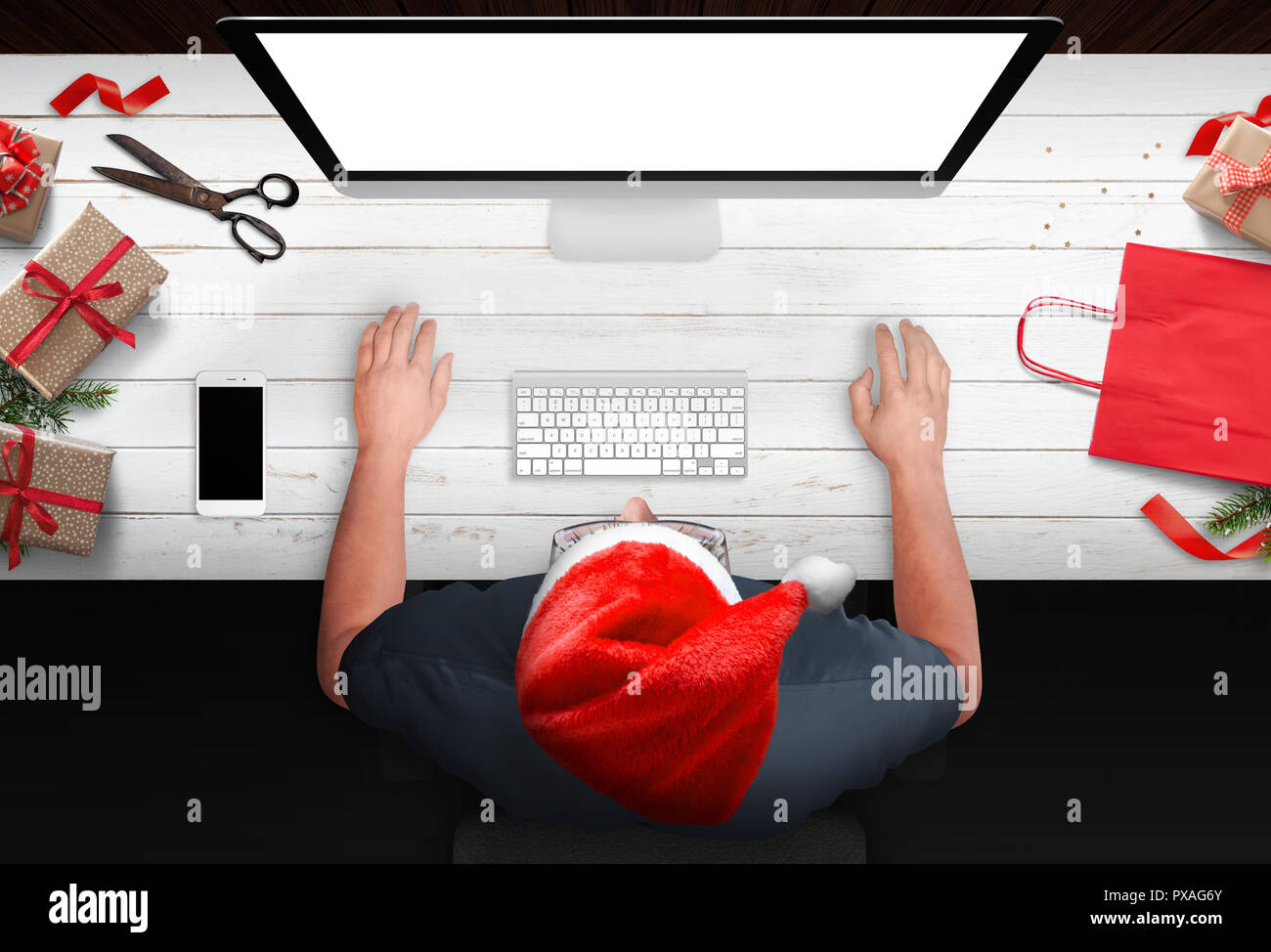 Christmas shopping from the armchair. Man buy gifts online at discounts. Bag, strips and gifts beside. Isolated computer display for mockup. Stock Photo