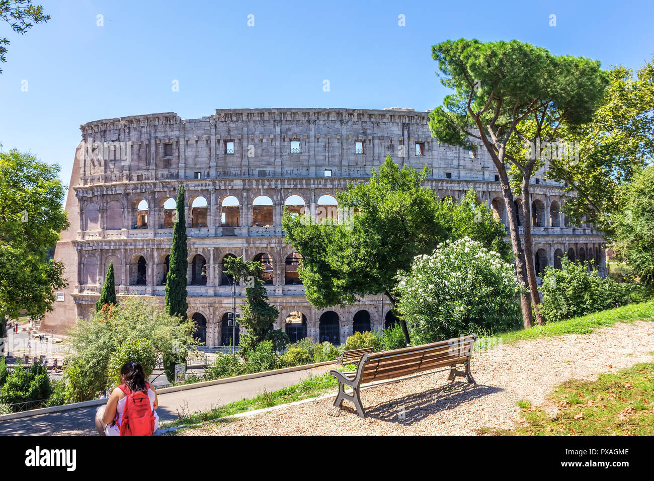 Rome/Italy - August 28, 2018: A teenage girl resting in the park in front of the Coliseum in Rome Stock Photo