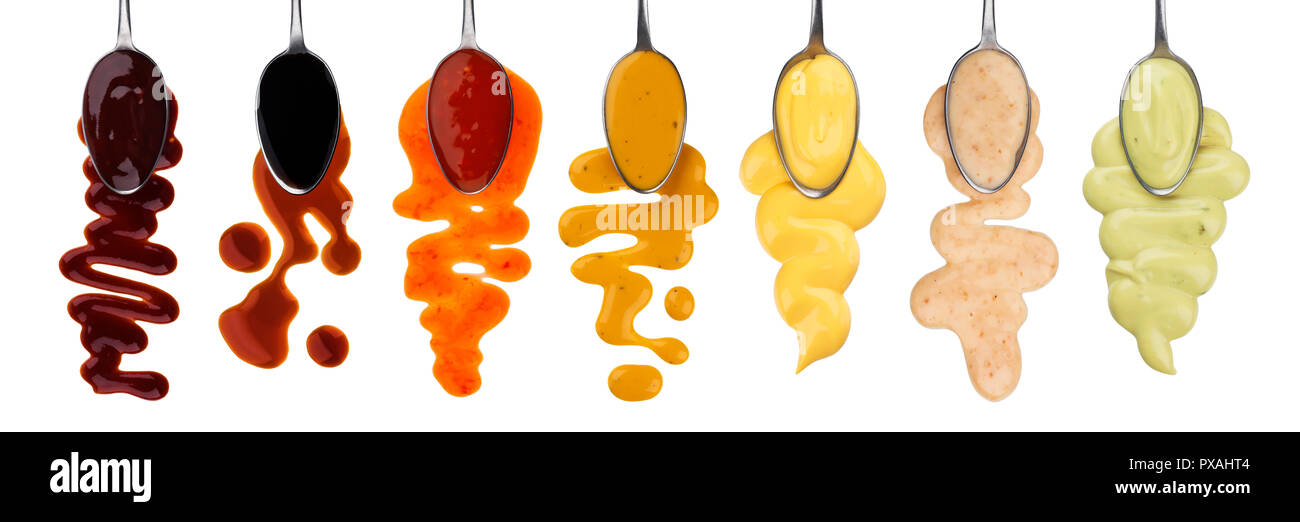 Different sauces with spoons isolated on white background Stock Photo