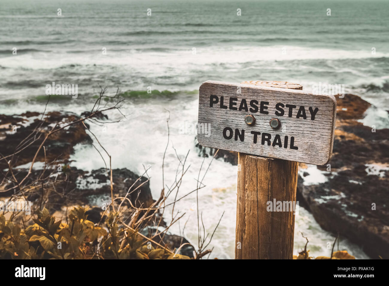 Please Stay on Trail wooden signpost along the Pacific Coast, Cape Perpetua, Yachats, Oregon, USA. Stock Photo