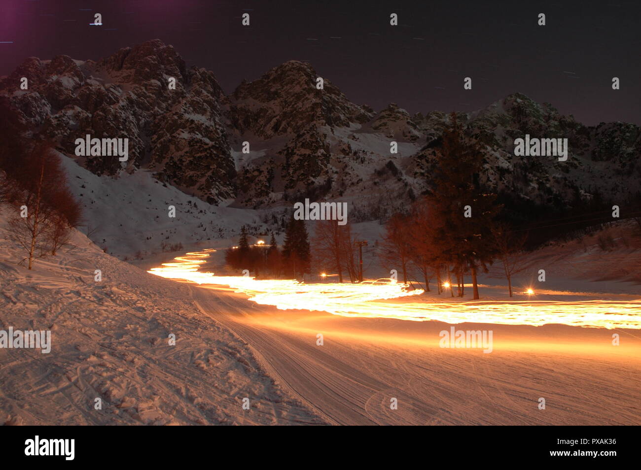 ski descent lit with torches Stock Photo