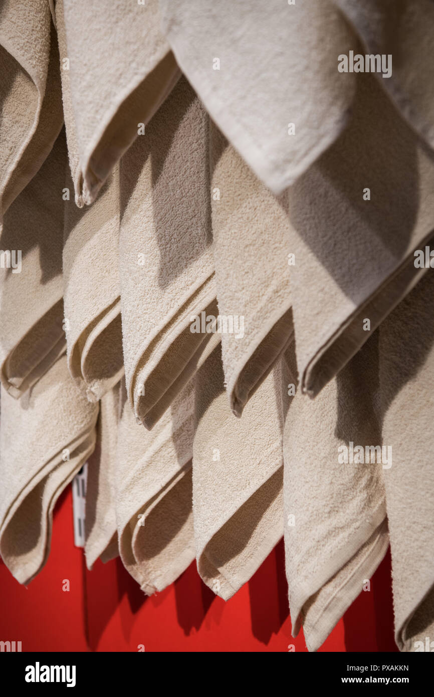 Soft towels drying on rack in bathroom Stock Photo