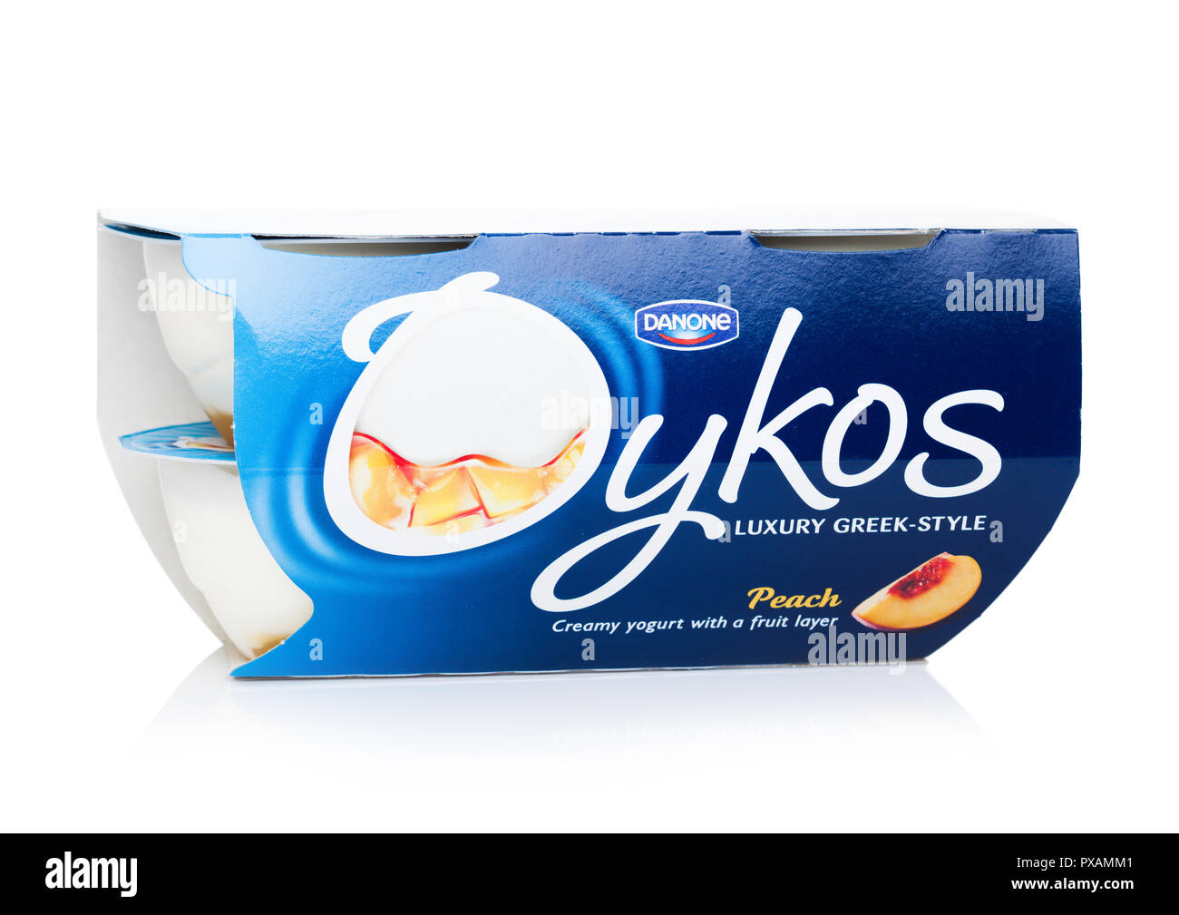 LONDON, UK - OCTOBER 20, 2018: Pack of Oykos luxury greek style creamy yogurt with fruit layer on white. Peach. Product by Danone. Stock Photo