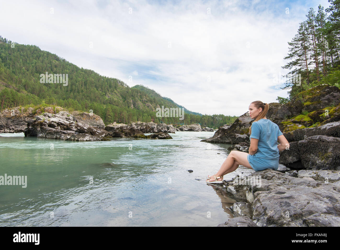 Woman resting at river Stock Photo - Alamy