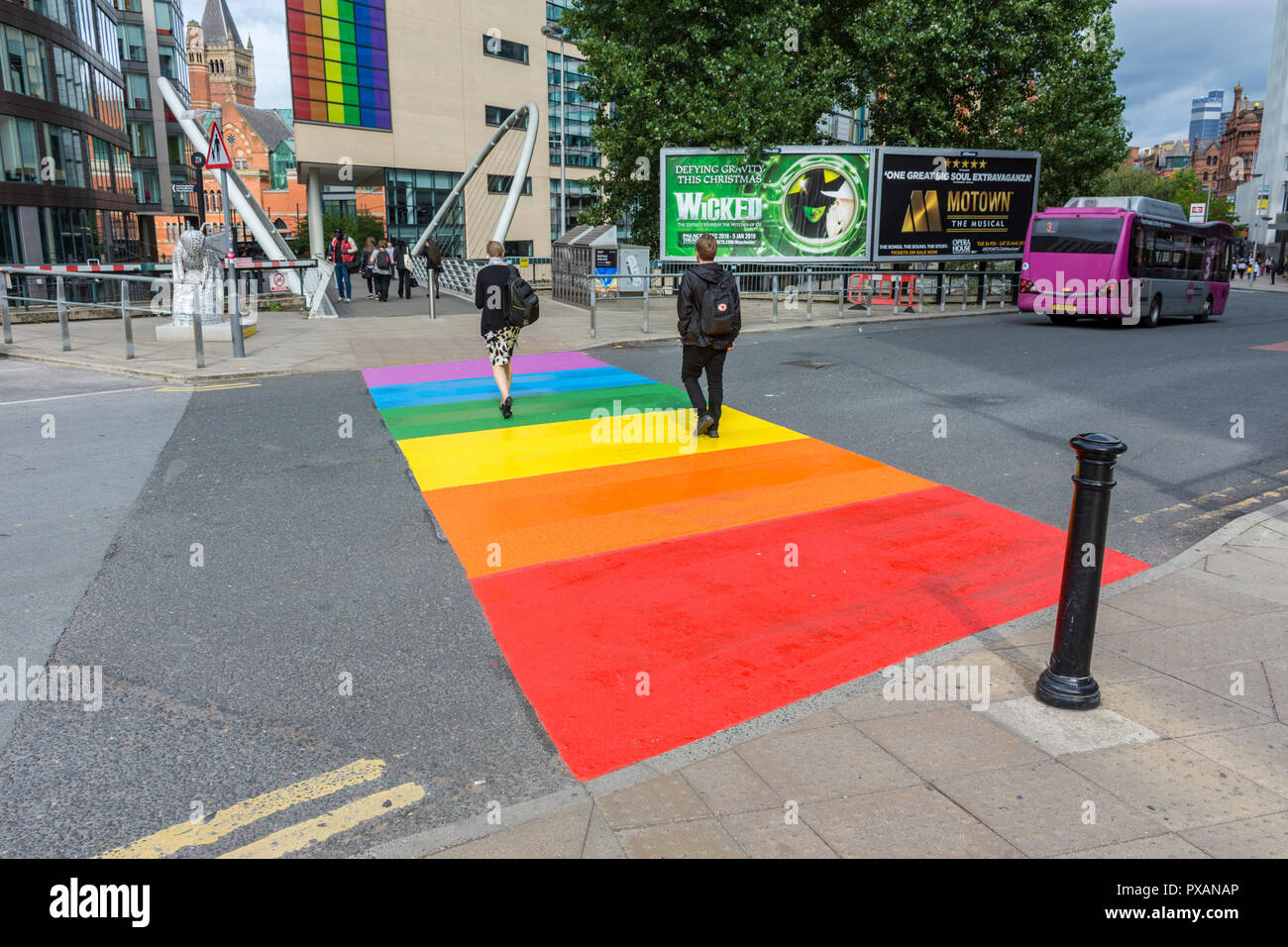 A pedestrian crossing painted with rainbow colours to celebrate the Manchester Pride festival, outside Piccadilly Station, Manchester, England, UK Stock Photo