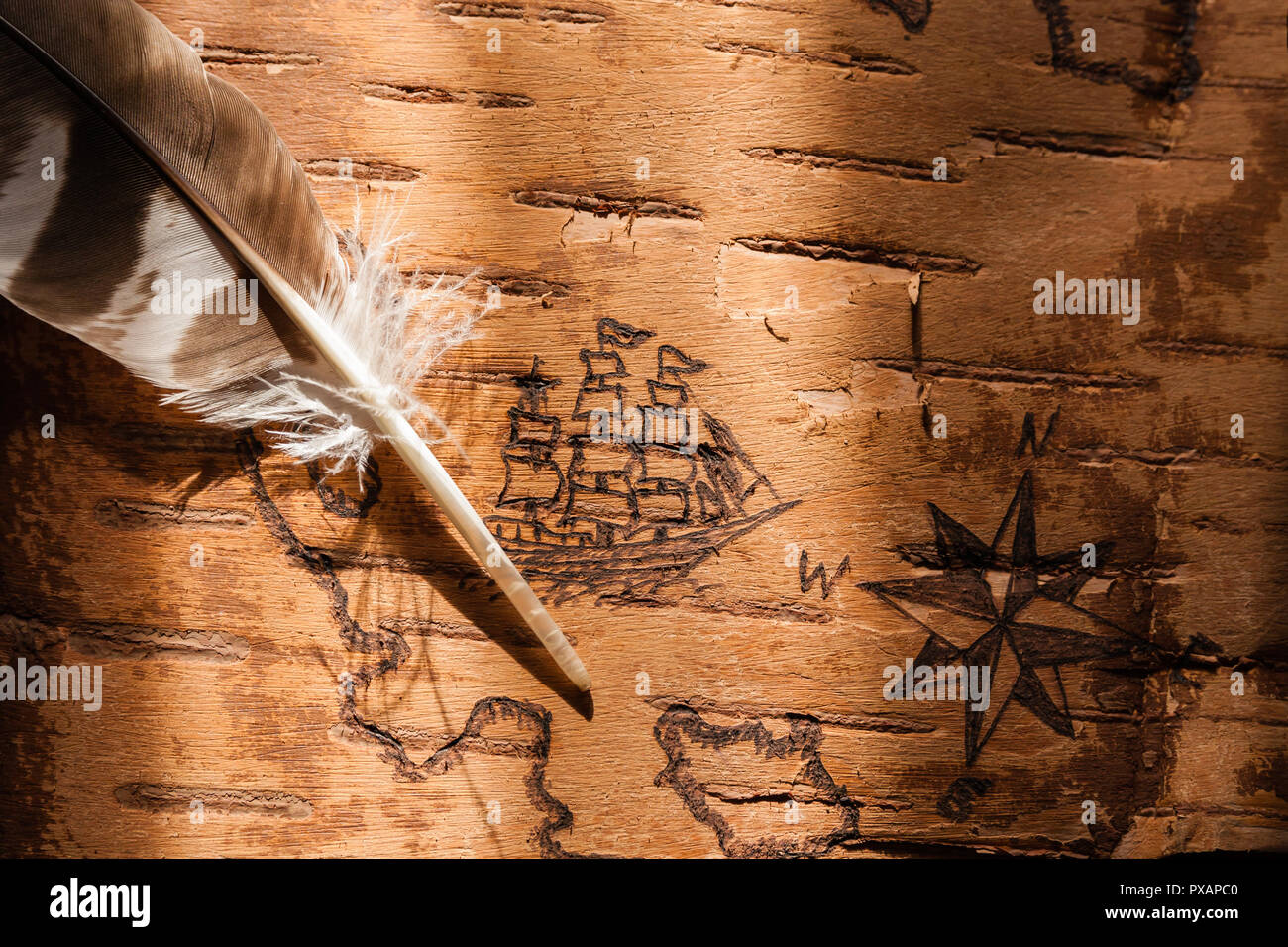Sea map with illustrations of sailing vessels and compass rose on the order of antiquities on birchbark Stock Photo