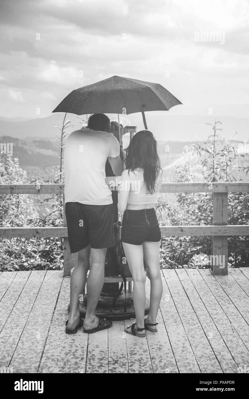 woman and man  under an umbrella Stock Photo