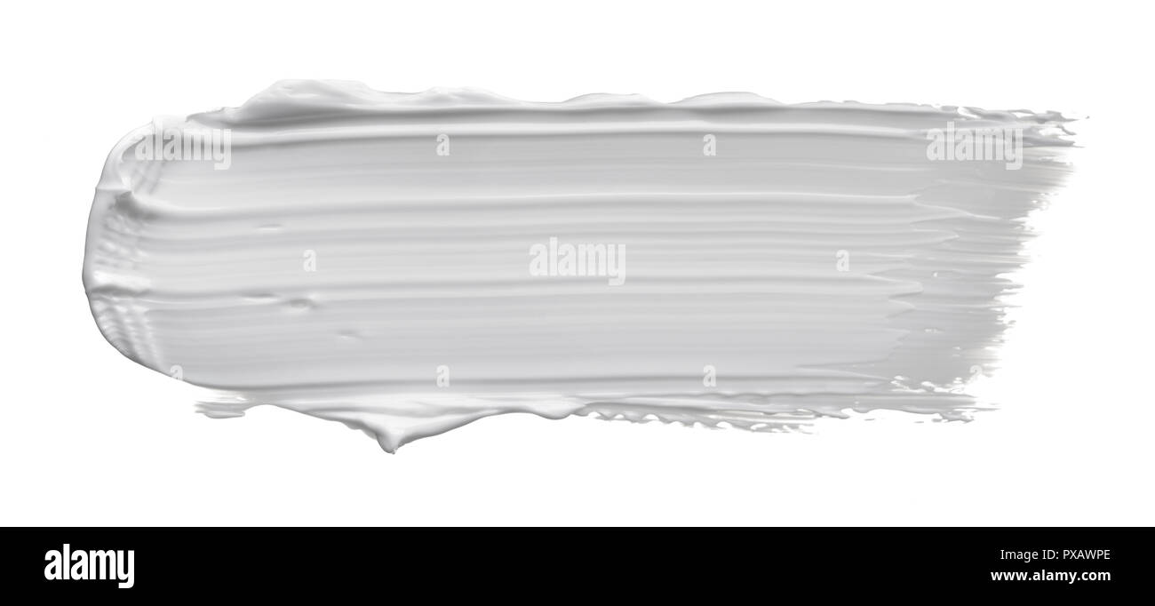 White smear of cosmetic cream or white acrylic paint isolated on white