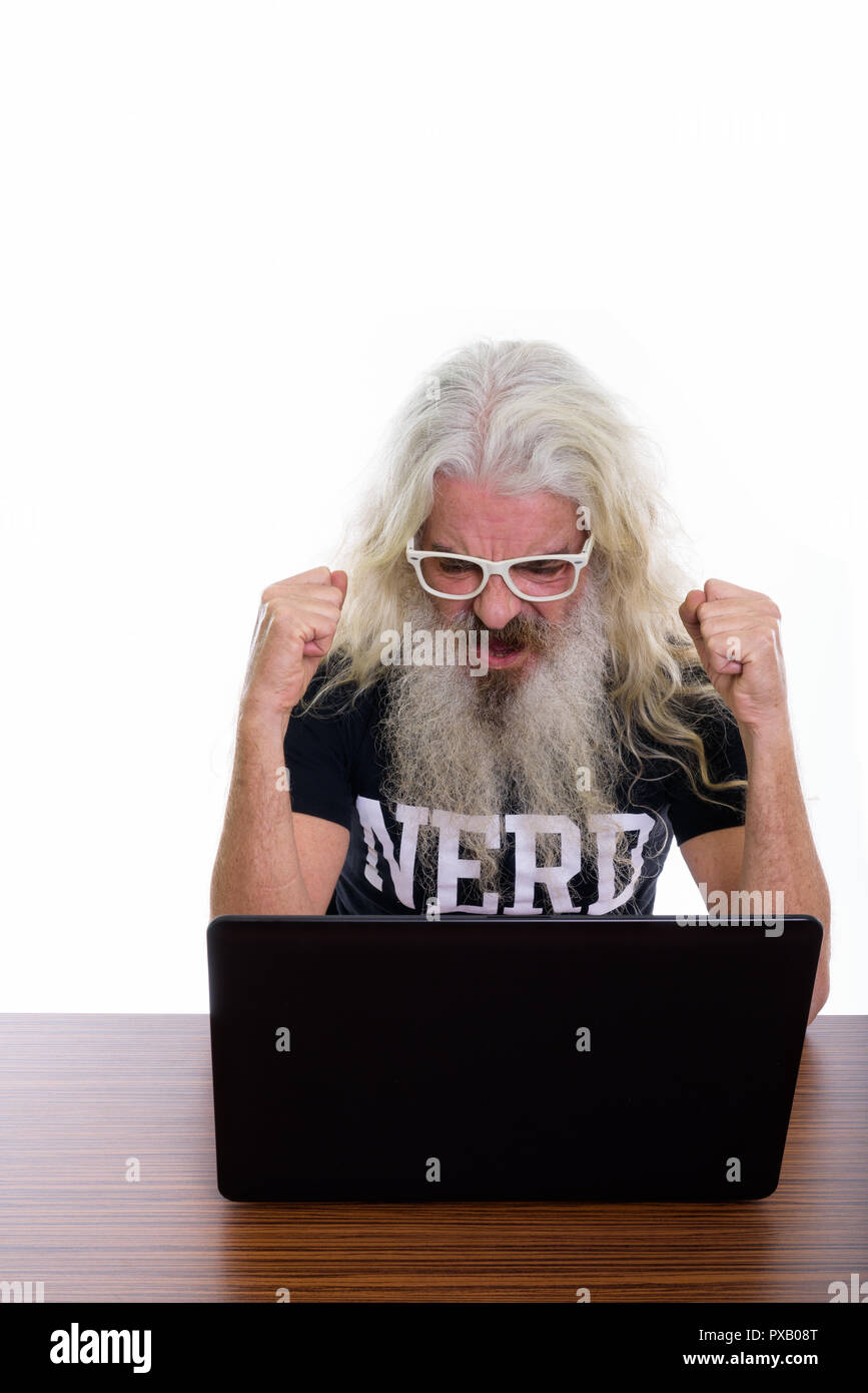 Studio shot of senior bearded nerd man looking motivated while u Stock Photo