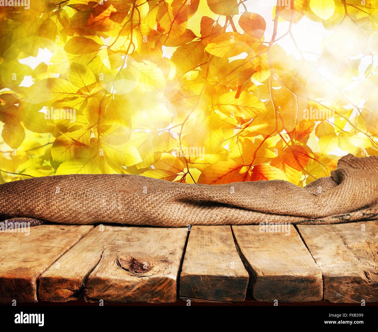 Empty wooden table and beautiful autumn leaves in background Stock ...