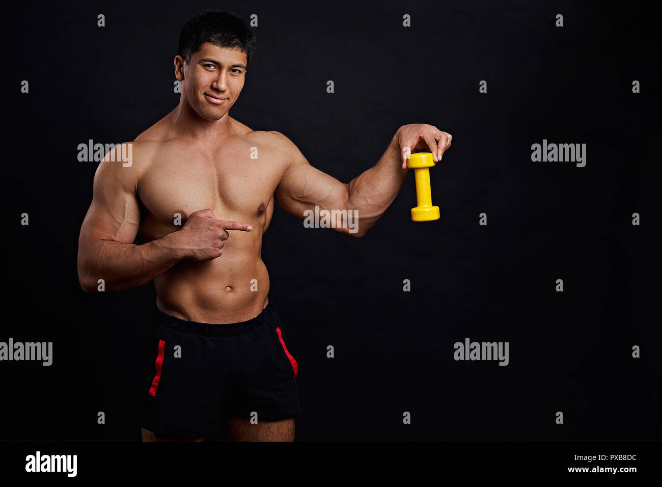 trainer is showing bodybulders' tool Stock Photo