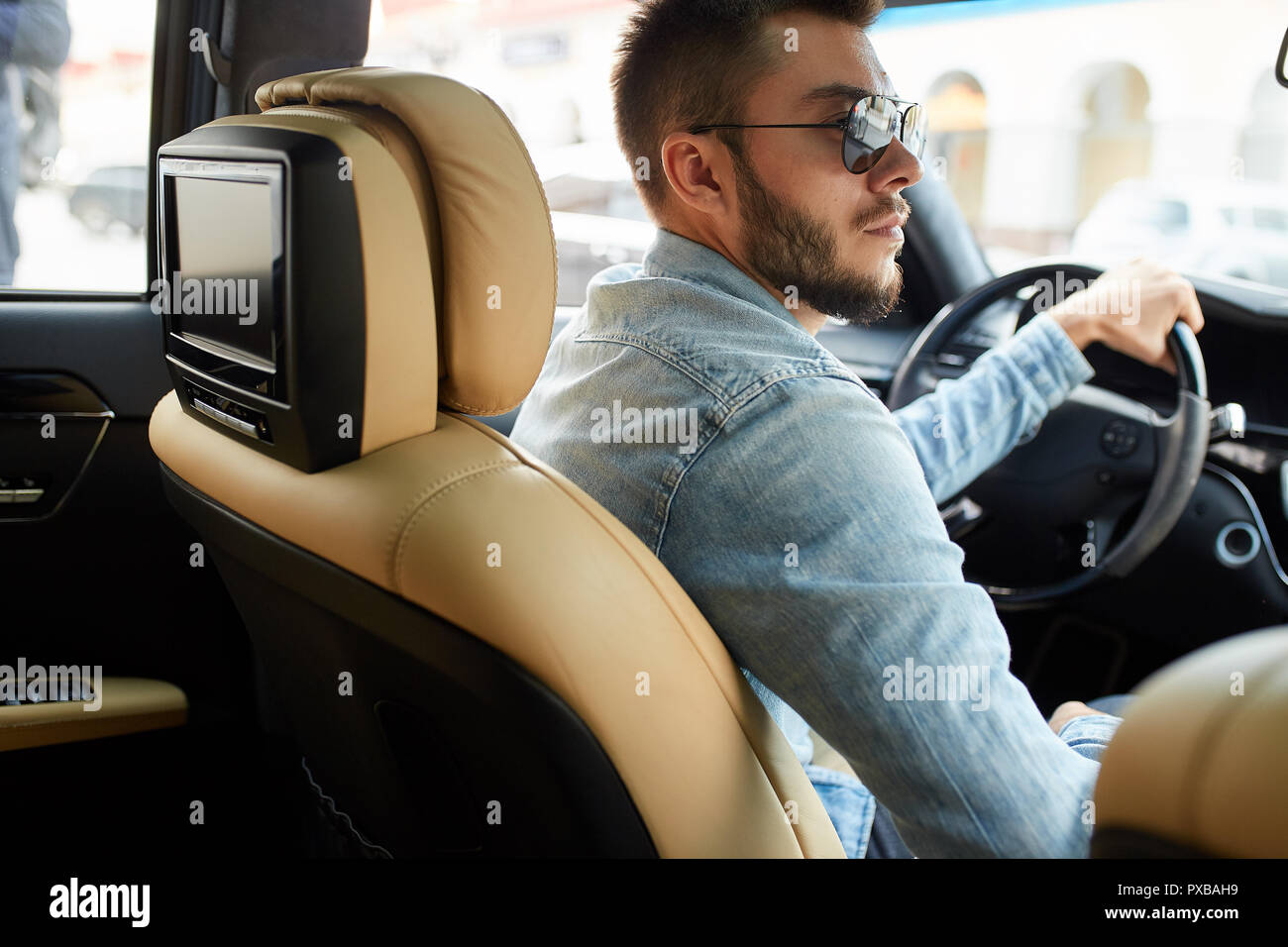 side view photo of a serious pensive driver Stock Photo - Alamy
