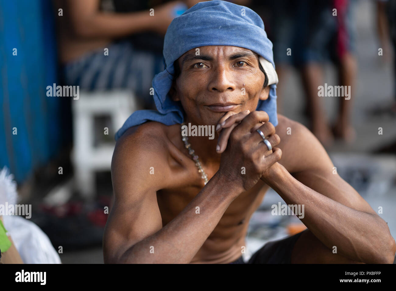 A Filipino man poses for a portrait on a sidewalk within Cebu City,Philippines Stock Photo