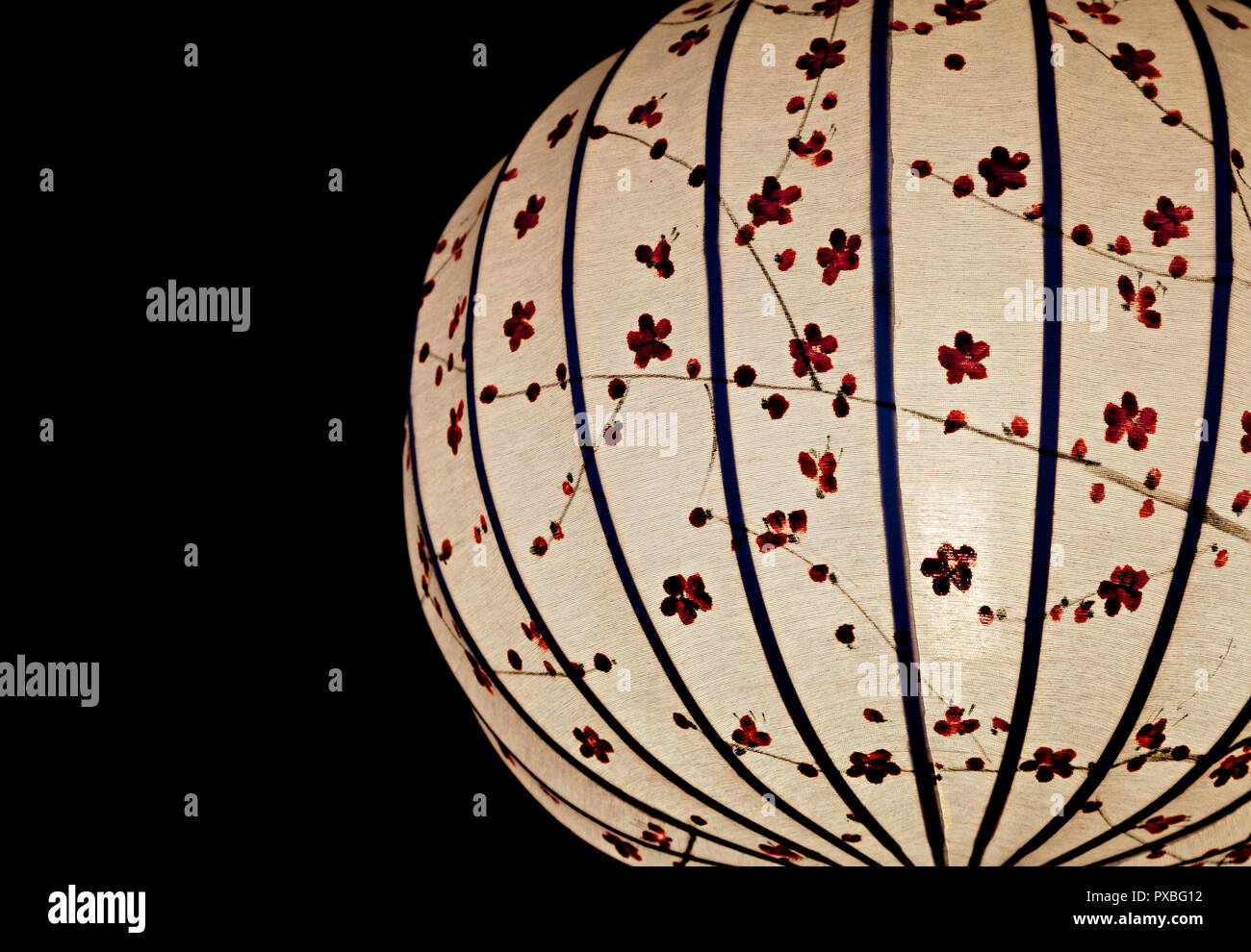 Close-up of white Chinese lantern over black background Stock Photo - Alamy